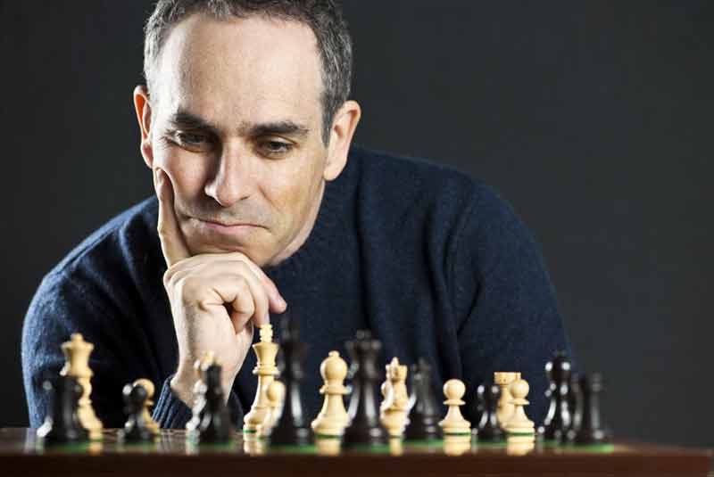 Man thinking hard about next chess move